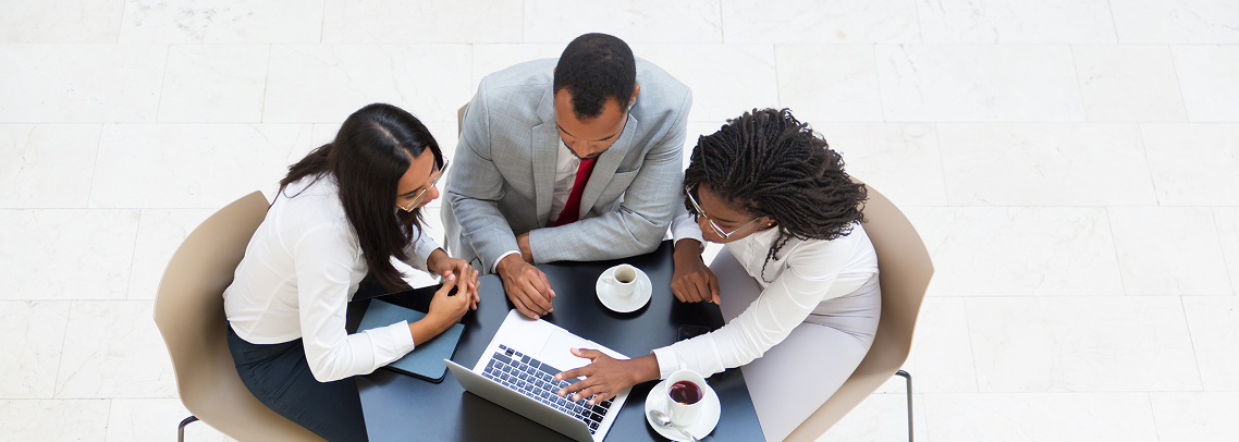 Team collaborating at a table (placeholder image)